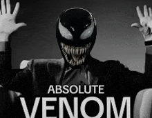 a man in a suit is wearing a venom mask