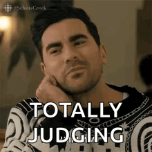a man with his hand on his chin says totally judging .
