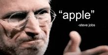 a man with glasses and a beard has a quote from steve jobs