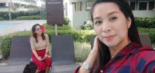 two women are taking a selfie in front of a sign that says " etiquette " on it