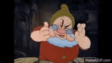 grumpy from snow white and the seven dwarfs is wearing glasses and making a funny face .