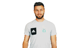 a man wearing an adidas t-shirt is smiling