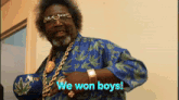 a man wearing a blue shirt that says we won boys on it
