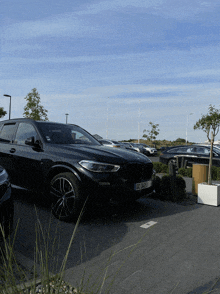 a black bmw is parked in a parking lot with a license plate that says gc-384-vt