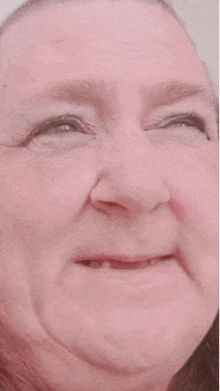 a close up of an elderly woman 's face with a funny face .