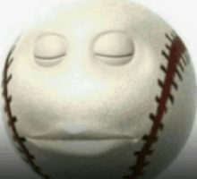 a close up of a baseball with a sad face on it