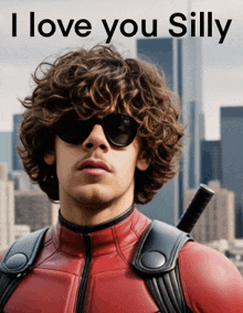 a man with curly hair is wearing sunglasses and a red superhero suit with the words i love you silly below him