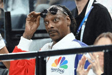 snoop dogg wearing sunglasses and a nbc shirt