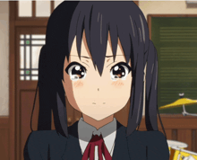 a girl with pigtails is crying in a classroom