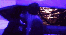 a blurry picture of a person in a dark room with a purple background