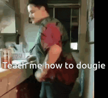 a man is standing in a kitchen with the words teach me how to dougie on the bottom