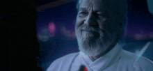 a man with a beard says " very good man " in a dark room