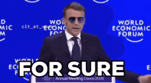 a man wearing sunglasses is giving a speech at the world economic forum annual meeting