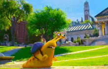 a cartoon snail is crawling across a grassy field