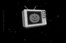 a television with a pumpkin on the screen is floating in the air .