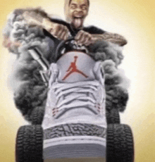 a man is riding a lawn mower made out of a pair of shoes