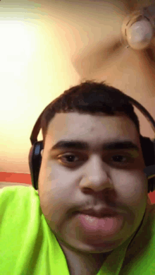 a man wearing headphones looks at the camera with his mouth open