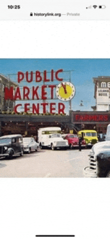 an old picture of the public market center with cars parked in front of it