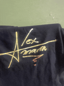 a black shirt with alex marsh written in gold