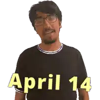 a man wearing glasses and a black shirt with the date april 14 on it
