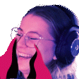 a woman wearing headphones and glasses is laughing and covering her face with her hands .