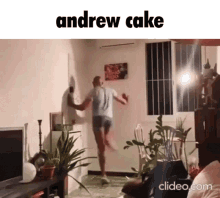 a man is dancing in a living room with the words andrew cake below him