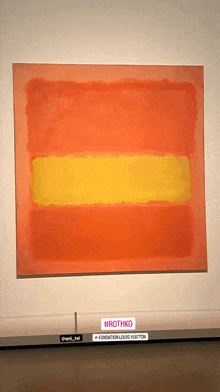 a large orange and yellow painting by rothko is on display