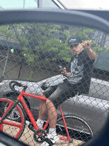 a man sitting on a bicycle with the word tribe on the front of it