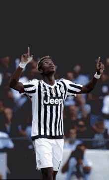 a soccer player wearing a black and white striped jersey with the word jeep on it