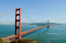 the golden gate bridge in san francisco with a boat passing underneath it