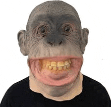 a person is wearing a chimpanzee mask with a large mouth .