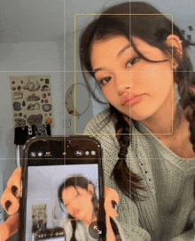 a girl is taking a picture of herself in the mirror