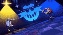 a man and a robot are standing on a stage with a skull behind them