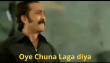 a man with a mustache is making a funny face with the words oye chuna laga diya written below him .