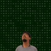a man stands in front of a green background with the number 16 on it