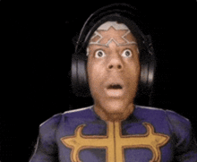 a man in a superhero costume is wearing headphones and has a surprised look on his face .