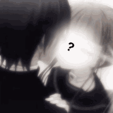 a man and a woman are kissing with a question mark on their face .