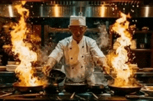 a chef is cooking food in a kitchen with a lot of flames coming out of the pans .