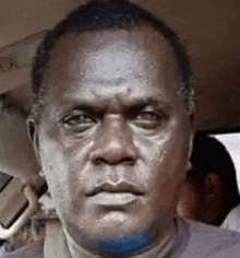 a close up of a man 's face with tears coming down his face .