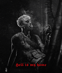 a black and white photo of a man smoking a cigarette with the words " hell is my home " above him