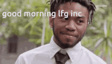 a man in a white shirt and tie is smiling and saying good morning lfg inc