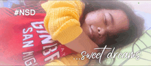 a girl in a yellow sweater is sleeping on a bed