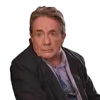 a man wearing a black jacket and a purple shirt is looking at the camera