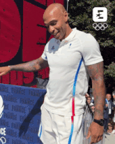 a man in a white shirt stands in front of a sign that says france
