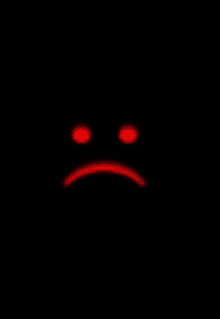 a sad smiley face with red eyes on a black background .