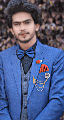 a man in a blue suit with a bow tie and a pocket square