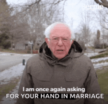 a man in a hooded jacket says i am once again asking for your hand in marriage