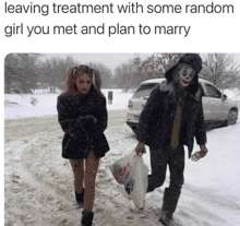 a man in a joker costume is walking in the snow with a woman .