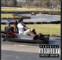 a man is riding a go kart with a parental advisory explicit content