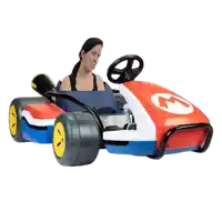 a woman is sitting in a red white and blue toy car with the number 4 on it